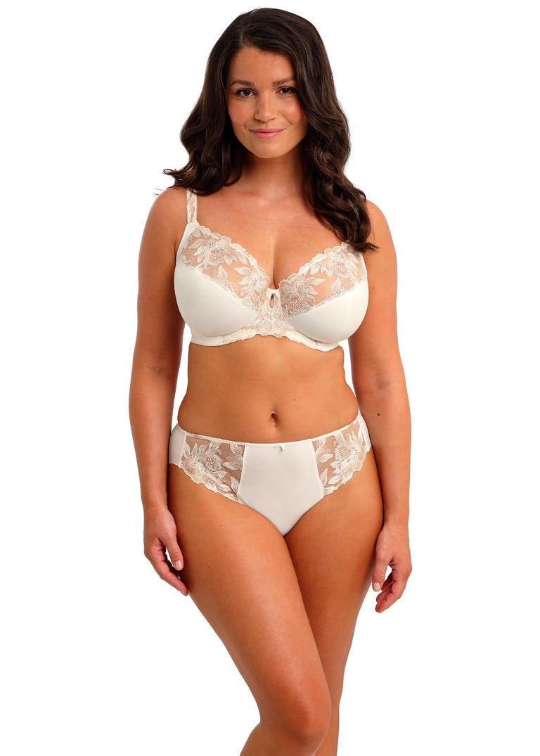 Woman wearing a white lace lingerie set on a white background available at Leia Lingerie
