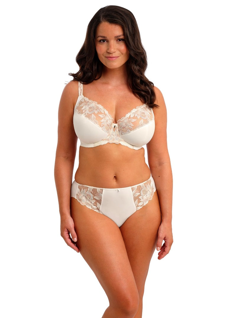 Woman wearing a white lace bra and panties set on a white background available at Leia Lingerie