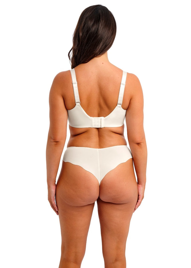 Woman wearing a beige bra and underwear set on a white background by Leia Lingerie