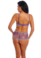 Woman wearing a purple lingerie set on a white background