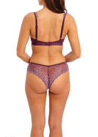 Wacoal's tanga brief in burgundy with pink lace worn by a person on a white background