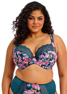 Woman wearing a floral bra and underwear set on a white background