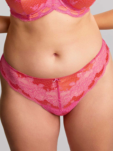 Woman wearing a Clara Thong in Pink and Coral with lace detail